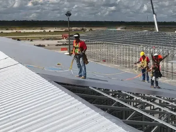 MetBuildings crew installing a steel roof on site